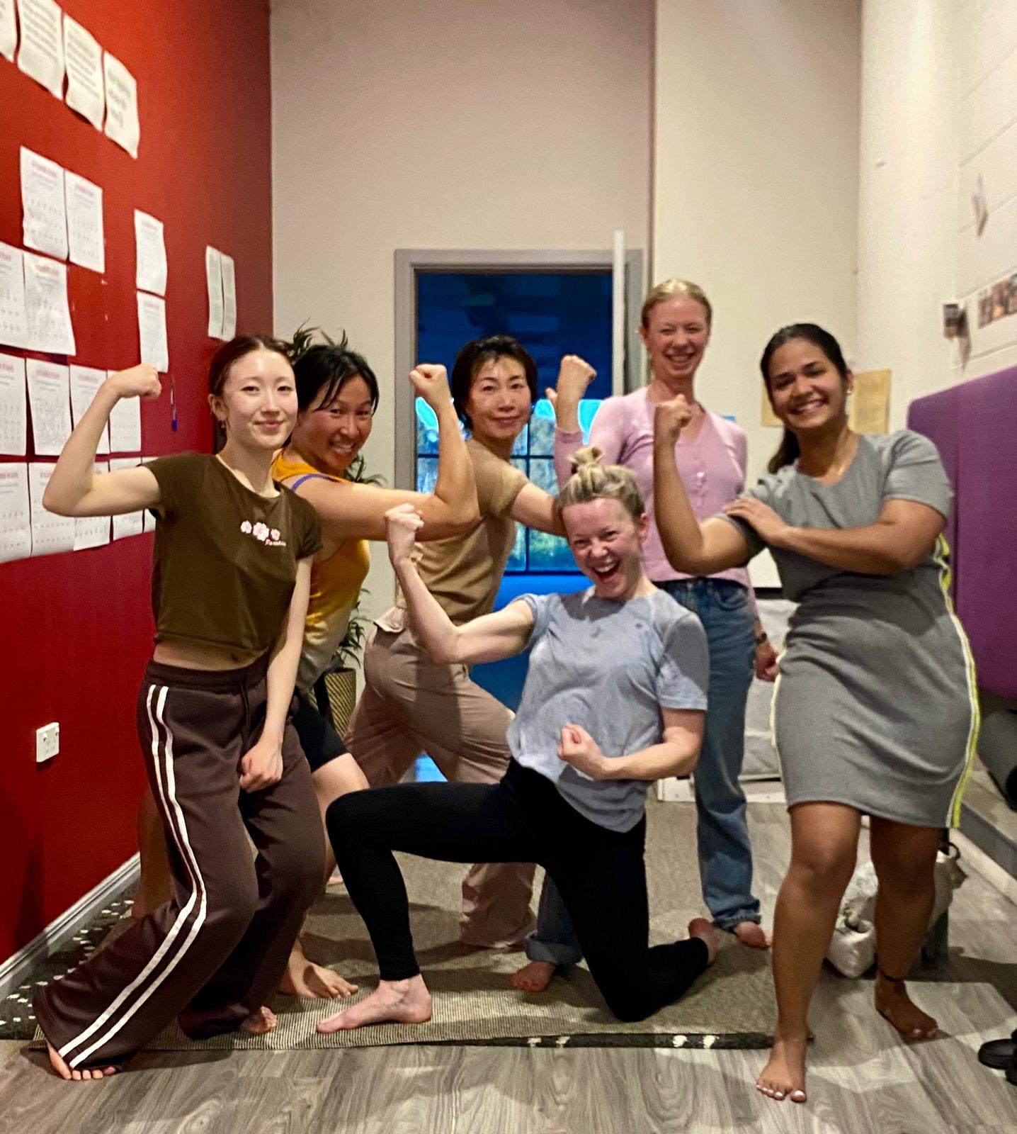 Happy students flexing after Bikram yoga class at Bella Vista